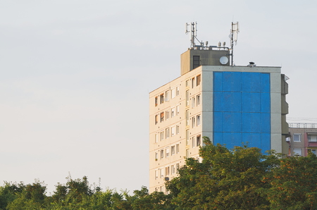 Panel Building and Green Trees on a Summer Day
