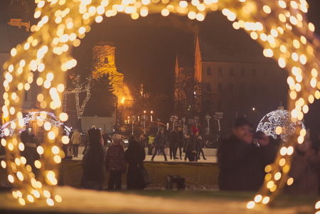 Ice Skaters on the Downtown Square In Gyor at Nightの写真素材