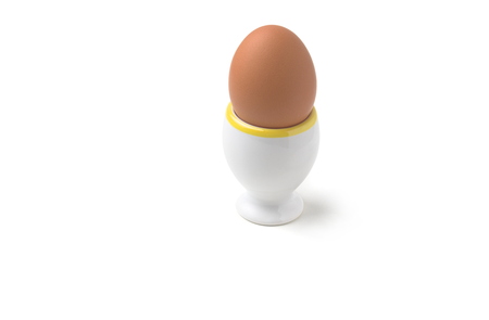 Chicken Egg in Egg Cup Isolated on White Backgroundの写真素材