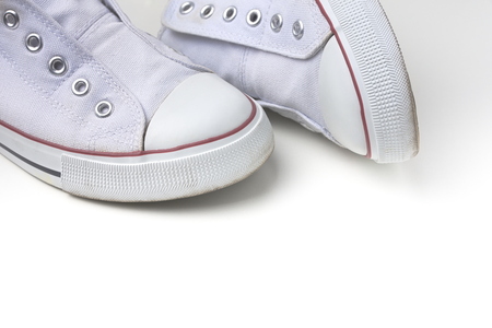 Pair of White Laceless Sneakers Isolated on White Backgroundの写真素材