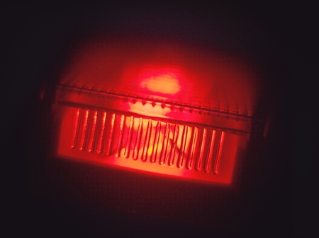 Glowing Red Power Switch in the Dark Macro Closeup