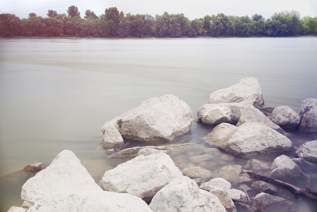 Long Exposure Danube Landscape with Tree Line and White Rocksの写真素材