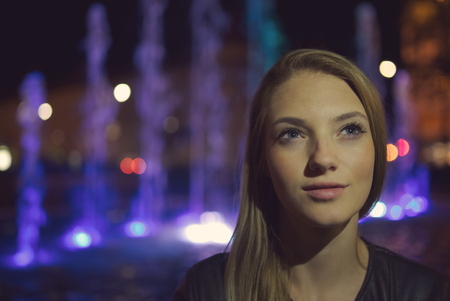 Teen Girl Night Portrait with Illuminated Fountainの写真素材