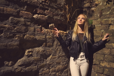 Teen Girl Night Portrait at Brick Wallの写真素材