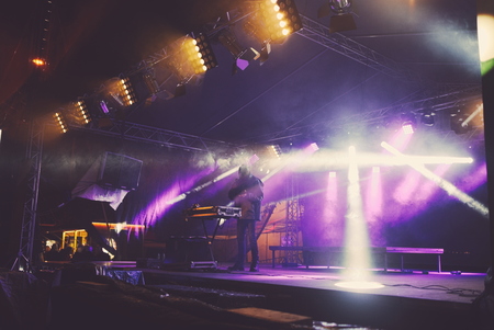 DJ on the Floodlit Stage Filled with Smokeの写真素材