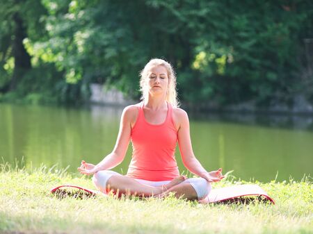 Woman in her Thirties Doing Yoga in the Park on a Summer Dayの写真素材