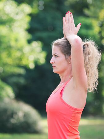 Woman in her Thirties Doing Yoga in the Park on a Summer Dayの写真素材