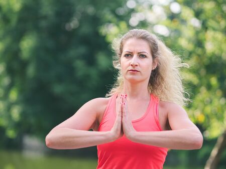 Woman in her Thirties Doing Yoga in the Park on a Summer Dayの写真素材