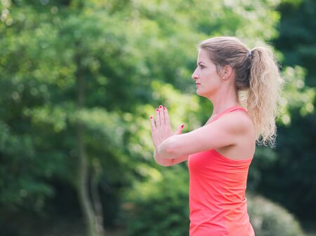 Woman in her Thirties Doing Yoga in the Park on a Summer Dayの写真素材