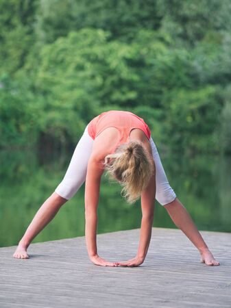 Woman in her Thirties Doing Yoga in the Park on a Pierの写真素材