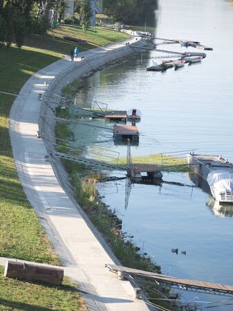 Riverside Promenade at Mosoni Danube River on a Sunny Autumn Day in GyÅr, Hungaryの写真素材