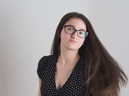 Portrait of a Smiling Bespectacled Long-haired Brunette Teen Girlの写真素材