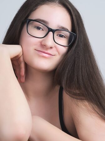 Portrait of a Smiling Bespectacled Long-haired Brunette Teen Girlの写真素材