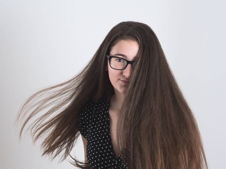 Portrait of a Bespectacled Long-haired Brunette Teen Girlの写真素材