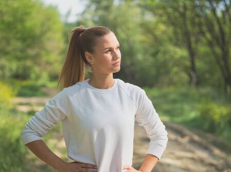 Young Blonde Caucasian Female Forest Runner Posingの写真素材
