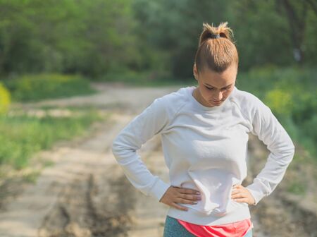 Young Blonde Caucasian Female Forest Runner Concentratingの写真素材