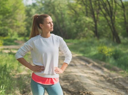 Young Blonde Caucasian Female Forest Runner Posingの写真素材
