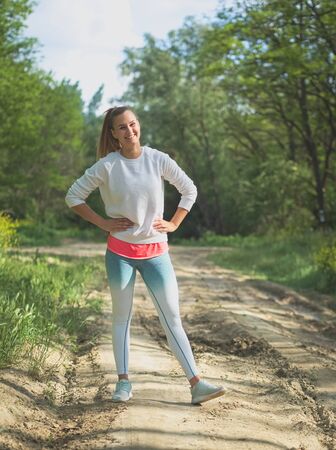 Young Blonde Caucasian Female Forest Runner Posingの写真素材