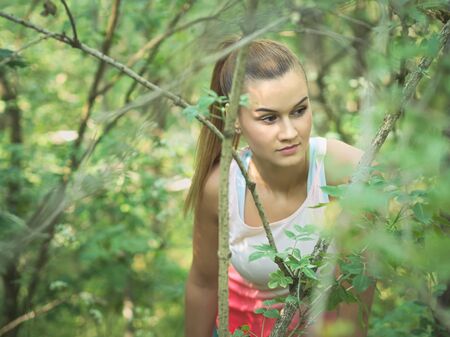 Young Blonde Caucasian Female Forest Runner Posingの写真素材