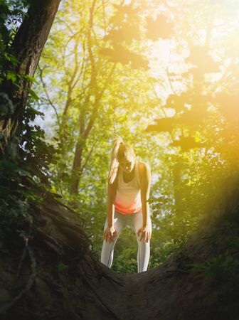 Young Blonde Caucasian Female Forest Runner Concentratingの写真素材