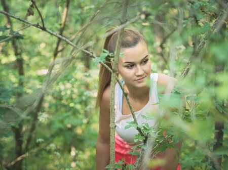 Young Blonde Caucasian Female Forest Runner Posingの写真素材