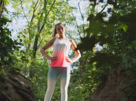 Young Blonde Caucasian Female Forest Runner Posingの写真素材