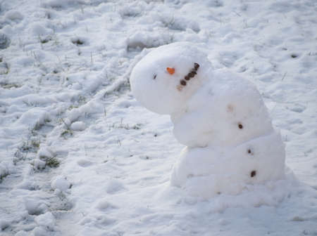 One Eyed Melting Snowman Leaned to the Sideの写真素材
