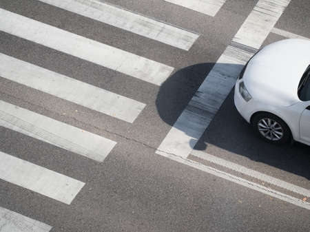 Top View of a Pedestrian Crosswalk with White Carの写真素材