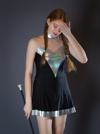 Redhead Teen Majorette Girl with Pigtails Concentrating in Studioの写真素材