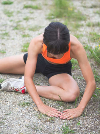 Pretty Young Skinny Woman Doing Exercises Outdoorsの写真素材