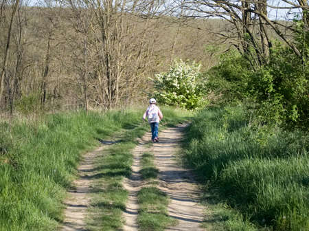 Little Girl Running away on a Dirt Roadの写真素材