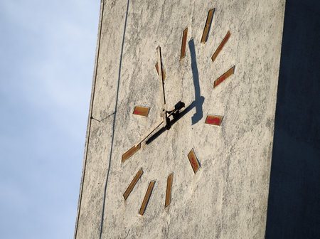 Modern Minimalist Tower Clock Closeup with Overcast Skyの写真素材