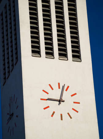 Modern Minimalist Tower Clock Closeup on a Sunny Dayの写真素材