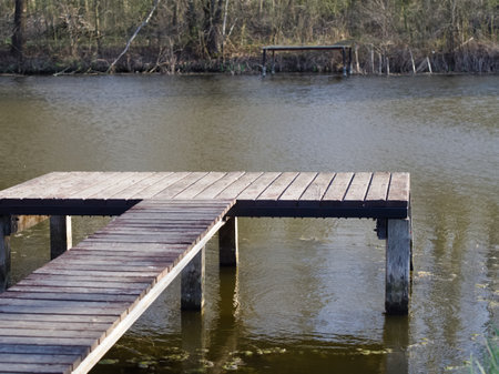 Wooden pier on the lake in the spring. Selective focus.の写真素材