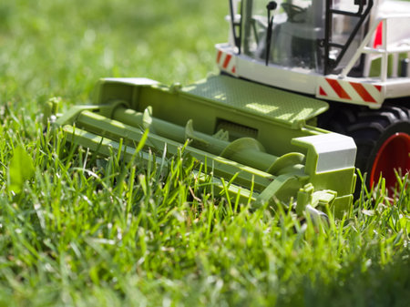 Combine Harvester Toy in Green Grass Closeupの写真素材