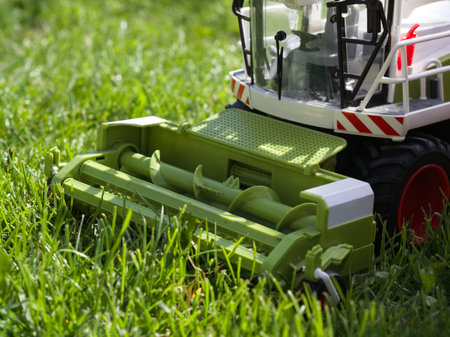 Combine Harvester Toy in Green Grass Closeupの写真素材