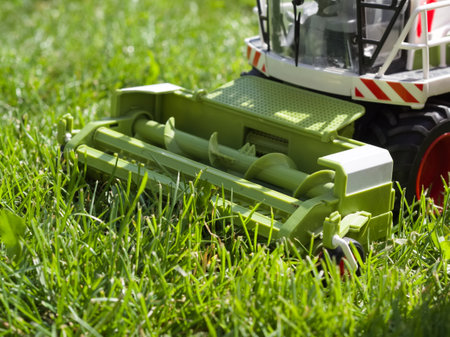 Combine Harvester Toy in Green Grass Closeupの写真素材