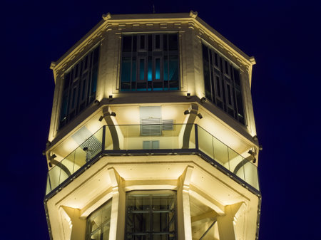 A close-up view of the illuminated upper sections and observation decks of the iconic SiÃ³fok Water Tower, glowing against a deep blue night sky, highlighting its intricate architectural details.の写真素材
