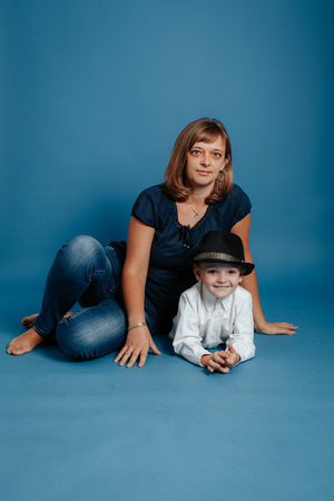 Mom and baby are sitting on the floor. On a blue background.の写真素材