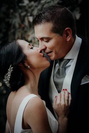 Happy wedding couple. Romantic moment before kiss. Beautiful wedding couple kissing and laughing. Pretty bride and stylish groom.の写真素材
