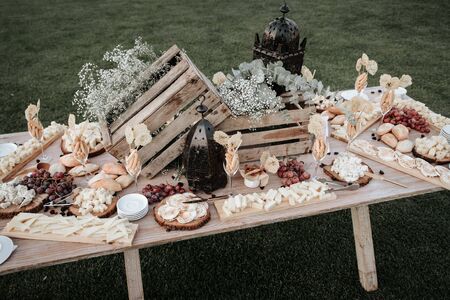 Assorted cheeses on wooden board plate table Camembert cheese, cheese grated bark of oak, hard...