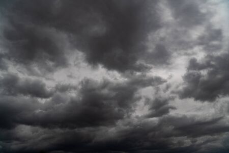 Storm is coming. Before heavy rain storm. On the sky is covered all over by the clouds. A lot of lightning and strong wind. The dark clouds is look like a big black smoke from erupting volcanoの写真素材