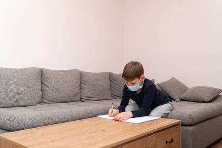 Coronavirus Epidemic. Isolated child Quarantined at Home in mask. Distance education and learning. Self isolation, home quarantine. World Crisis COVID-19. Distance learning at home.の写真素材