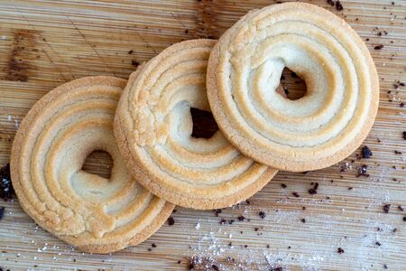Recipe of homemade pastry. Bagel shortbread cookies on a wooden table. Tasty Danish butter cookies....