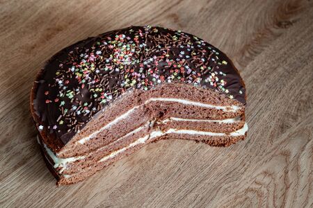 Delicious chocolate cake on plate on table on dark background. Top view. Copy space.の写真素材