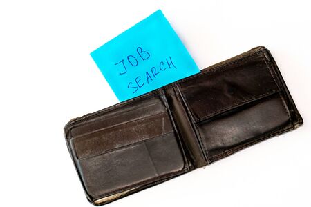 Notebook with job search phrase and open old shabby empty wallet purse, on white background....