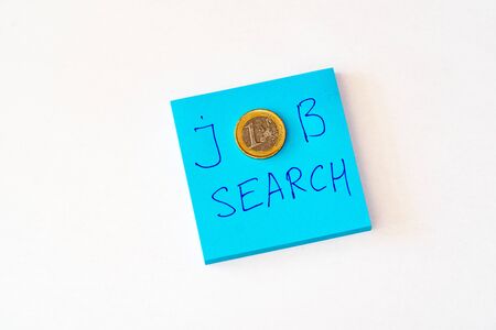 Looking for a job concept - Blue notebook with job search phrase. One euro money. Flat lay white backgroundの写真素材