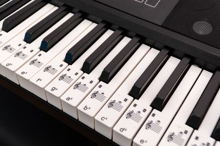 Piano side view with keys lost in the light.