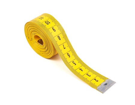 Yellow measuring tape on a white background の写真素材