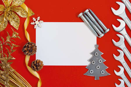 Blank Christmas card on a red background with tools and decorations.の写真素材